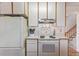 Kitchen featuring white appliances, ample counter space, and nearby stairway at 11237 W 59Th Ave, Arvada, CO 80004