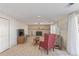 Spacious living room featuring a brick fireplace, wood floors, and ample seating at 11237 W 59Th Ave, Arvada, CO 80004