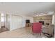 Open living room featuring a brick fireplace, wood floors, and cozy seating at 11237 W 59Th Ave, Arvada, CO 80004