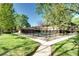 Community pool surrounded by lush greenery and well-maintained lawns at 600 Manhattan Dr # 4C, Boulder, CO 80303