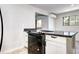 Modern kitchen featuring a black stovetop, gray countertop, and white cabinets at 600 Manhattan Dr # 4C, Boulder, CO 80303