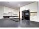 Bright kitchen featuring a black cooktop, gray countertops, and white cabinetry at 600 Manhattan Dr # 4C, Boulder, CO 80303