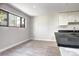 Corner kitchen with a large window, gray countertops, and tiled flooring at 600 Manhattan Dr # 4C, Boulder, CO 80303