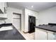 Kitchen featuring granite countertops, a black refrigerator, and white cabinetry at 600 Manhattan Dr # 4C, Boulder, CO 80303