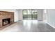 Living room with a brick fireplace, tile floors, and sliding glass doors leading to a balcony at 600 Manhattan Dr # 4C, Boulder, CO 80303
