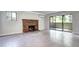 Bright living room with a brick fireplace, tile floors, and sliding glass doors to a balcony at 600 Manhattan Dr # 4C, Boulder, CO 80303