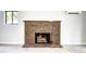 Living room featuring a brick fireplace, tile flooring, and a window for natural light at 600 Manhattan Dr # 4C, Boulder, CO 80303