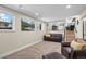 Finished basement with a comfortable seating area, multiple windows, and a view to upper floor at 8334 Allison Ct, Arvada, CO 80005