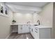Finished basement featuring white cabinets, countertop, a sink, and modern touches at 8334 Allison Ct, Arvada, CO 80005