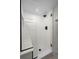 Modern bathroom with subway tile shower, glass door and shower bench at 8334 Allison Ct, Arvada, CO 80005
