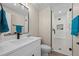 Updated bathroom featuring modern sink, white cabinets, mirror, and glass-enclosed shower at 8334 Allison Ct, Arvada, CO 80005