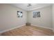 Bright bedroom with hardwood floors, dual windows, and modern light fixture at 8334 Allison Ct, Arvada, CO 80005