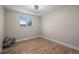 Bright bedroom with wood flooring, a large window for natural light, and modern fixtures at 8334 Allison Ct, Arvada, CO 80005