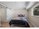 Bedroom features wood floors, modern closet doors, large window, and natural light at 8334 Allison Ct, Arvada, CO 80005