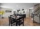 Dining area leading to a kitchen with an island, showcasing an open-concept floor plan at 8334 Allison Ct, Arvada, CO 80005
