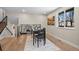 Modern dining area with a black table, a view out of the window and fireplace in the background at 8334 Allison Ct, Arvada, CO 80005