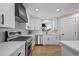 Modern kitchen featuring white cabinets, stainless steel appliances, and a subway tile backsplash at 8334 Allison Ct, Arvada, CO 80005