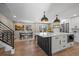 Modern kitchen featuring a large island, stainless steel appliances, and hardwood floors at 8334 Allison Ct, Arvada, CO 80005