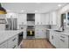Bright white kitchen featuring stainless steel appliances and modern black hardware at 8334 Allison Ct, Arvada, CO 80005