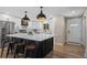 Modern kitchen with a large center island, stainless steel appliances, and stylish pendant lighting at 8334 Allison Ct, Arvada, CO 80005
