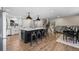 Modern kitchen with a large center island, stainless steel appliances, and stylish pendant lighting at 8334 Allison Ct, Arvada, CO 80005