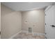 A well-lit laundry room featuring tiled floors and a modern washer and dryer hook-up at 8334 Allison Ct, Arvada, CO 80005