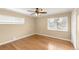 This spacious bedroom features hardwood floors, a ceiling fan, and bright, natural light from dual windows at 4545 E Harvard Ave, Denver, CO 80222