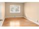 Cozy bedroom with hardwood floors and natural light from a large window at 4545 E Harvard Ave, Denver, CO 80222