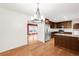 Bright dining area featuring hardwood floors, modern chandelier, and access to the updated kitchen at 4545 E Harvard Ave, Denver, CO 80222