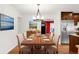 Dining room featuring hardwood floors, modern chandelier and view into the living room at 4545 E Harvard Ave, Denver, CO 80222