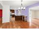 Dining area featuring modern lighting and a view of the kitchen with stainless appliances at 4545 E Harvard Ave, Denver, CO 80222