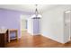 Dining room with chandelier, adjacent to an open doorway and beautiful hardwood flooring at 4545 E Harvard Ave, Denver, CO 80222