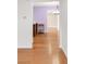 Bright living room featuring hardwood floors with view into kitchen at 4545 E Harvard Ave, Denver, CO 80222