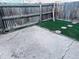 Small backyard with artificial grass, concrete pad and wooden fence at 12223 E Ford E Ave # 12223, Aurora, CO 80012