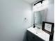 Powder room features modern vanity, a mirror and attractive lighting fixture at 12223 E Ford E Ave # 12223, Aurora, CO 80012