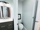This bathroom features modern vanity with granite countertops and artwork above the toilet at 12223 E Ford E Ave # 12223, Aurora, CO 80012