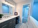 Bathroom featuring a large mirror, modern vanity, and an open-concept shower at 12223 E Ford E Ave # 12223, Aurora, CO 80012