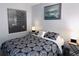 Bedroom featuring carpet flooring, a large window, and a comfortable bed with stylish black and white bedding at 12223 E Ford E Ave # 12223, Aurora, CO 80012