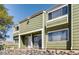 Exterior view of townhome with green siding and white trim at 12223 E Ford E Ave # 12223, Aurora, CO 80012