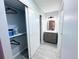 View of a hallway with a closet and a bathroom with modern vanity at 12223 E Ford E Ave # 12223, Aurora, CO 80012