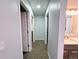 Hallway view with multiple rooms and a partial view of the bathroom featuring a marble counter at 12223 E Ford E Ave # 12223, Aurora, CO 80012