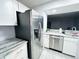 Updated kitchen features stainless steel refrigerator, granite countertops and white cabinetry at 12223 E Ford E Ave # 12223, Aurora, CO 80012