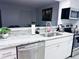 Modern kitchen features stainless steel appliances, granite countertops, and white cabinets at 12223 E Ford E Ave # 12223, Aurora, CO 80012