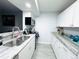 The kitchen includes white cabinets, stone countertops, stainless appliances and tiled floor at 12223 E Ford E Ave # 12223, Aurora, CO 80012