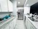 Bright kitchen features stone countertops, stainless steel appliances and gray tiled floors at 12223 E Ford E Ave # 12223, Aurora, CO 80012