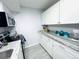 Bright kitchen features stone countertops, tiled floors and new white cabinetry at 12223 E Ford E Ave # 12223, Aurora, CO 80012