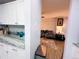 View from the kitchen into a cozy living room with seating and decor at 12223 E Ford E Ave # 12223, Aurora, CO 80012
