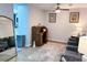 Cozy living room with wood floors, ceiling fan and vintage roll top desk at 12223 E Ford E Ave # 12223, Aurora, CO 80012