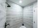 The shower features modern gray tiling with a brushed nickel shower head at 12223 E Ford E Ave # 12223, Aurora, CO 80012
