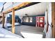 Covered patio with a ceiling fan and red door access at 14409 W Yale Pl, Lakewood, CO 80228